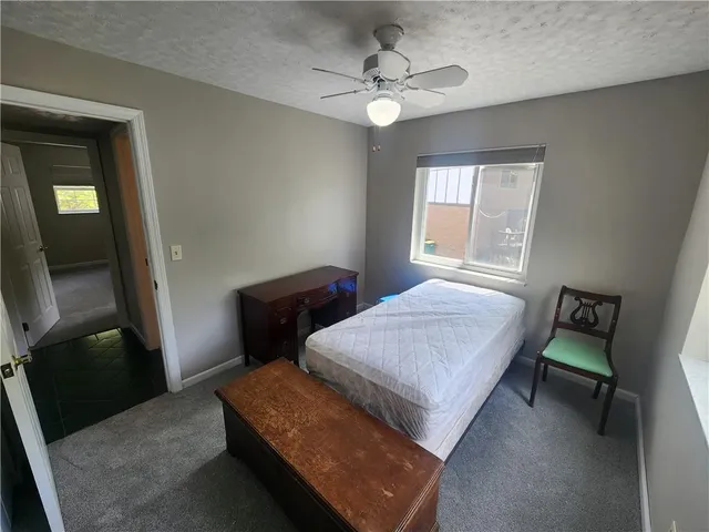 a bed sitting in a bedroom next to a window