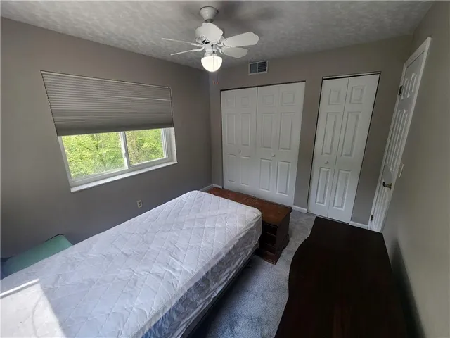 a bathroom with a sink a toilet a mirror and shower