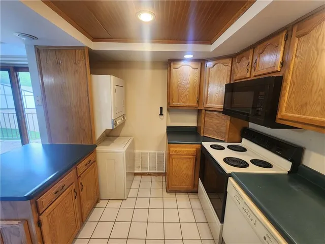 a kitchen with stainless steel appliances a refrigerator and wooden floor