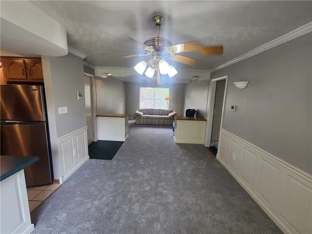 a view of a kitchen with a refrigerator a microwave and a sink