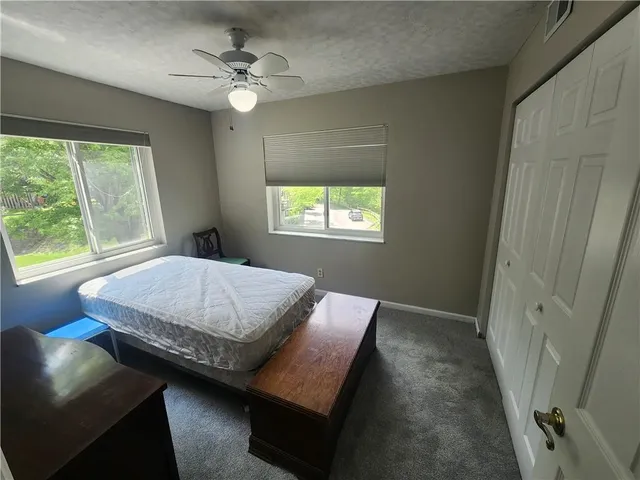 a bedroom with a bed lamp and a window