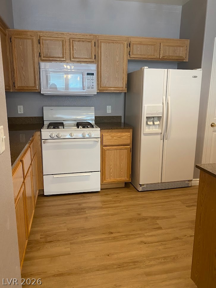10550 West Alexander Road, Unit 2210 Las Vegas, NV 89129 - Photo 7 of 14 Well-lit kitchen with generous countertop space, abundant cabinet storage, and functional appliances.