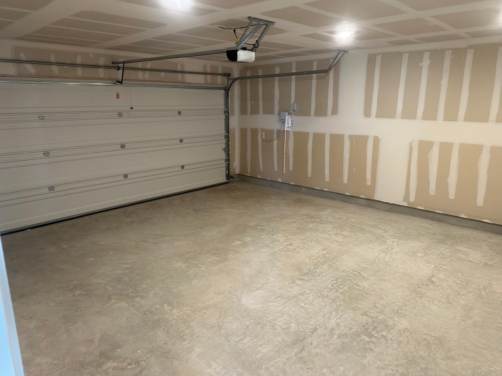 13832 Scarlett Song Drive Elgin, TX 78621 - Photo 10 of 19 Garage featuring a garage door opener