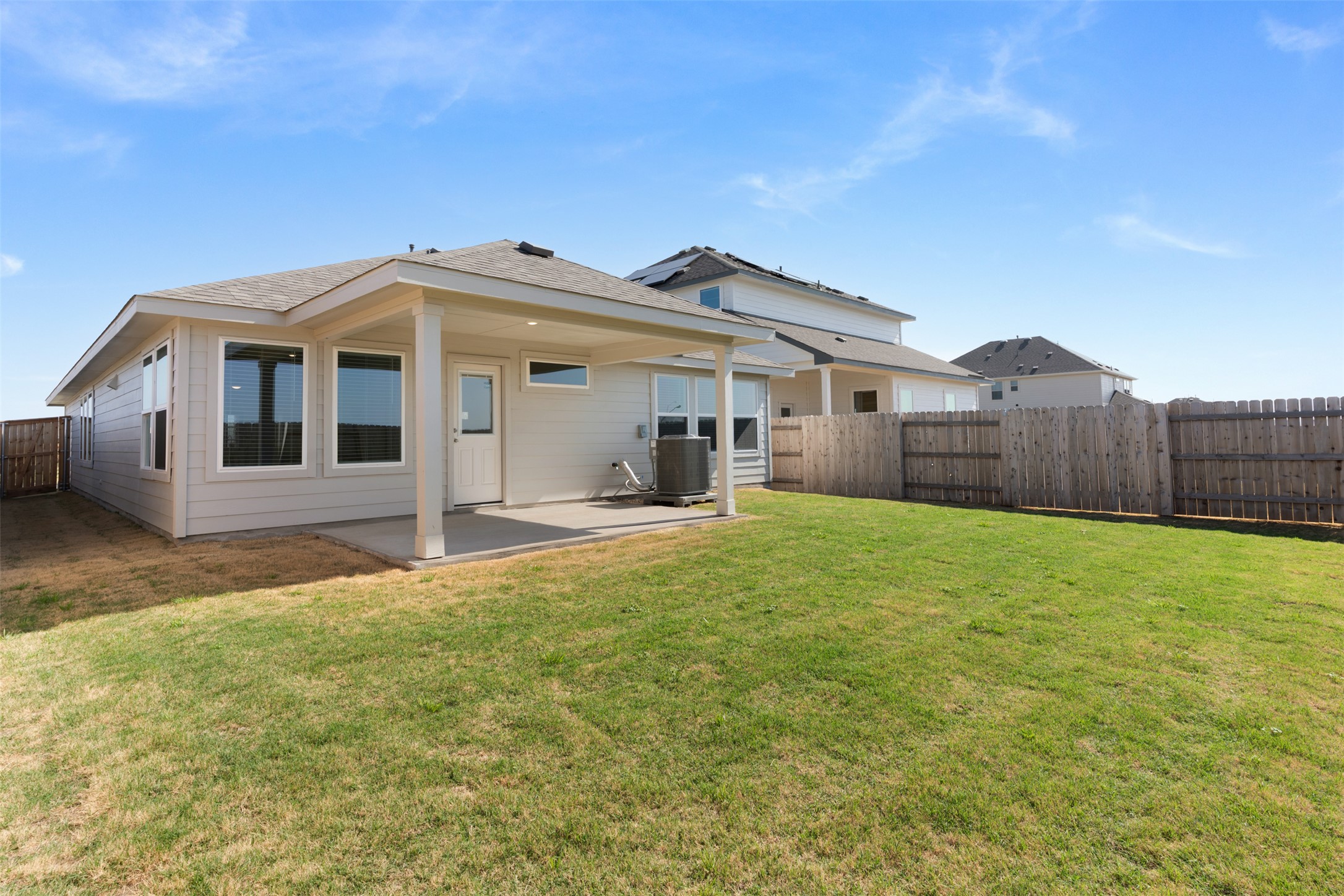 13832 Scarlett Song Drive Elgin, TX 78621 - Photo 19 of 26 Rear view of house featuring a fenced backyard and a patio