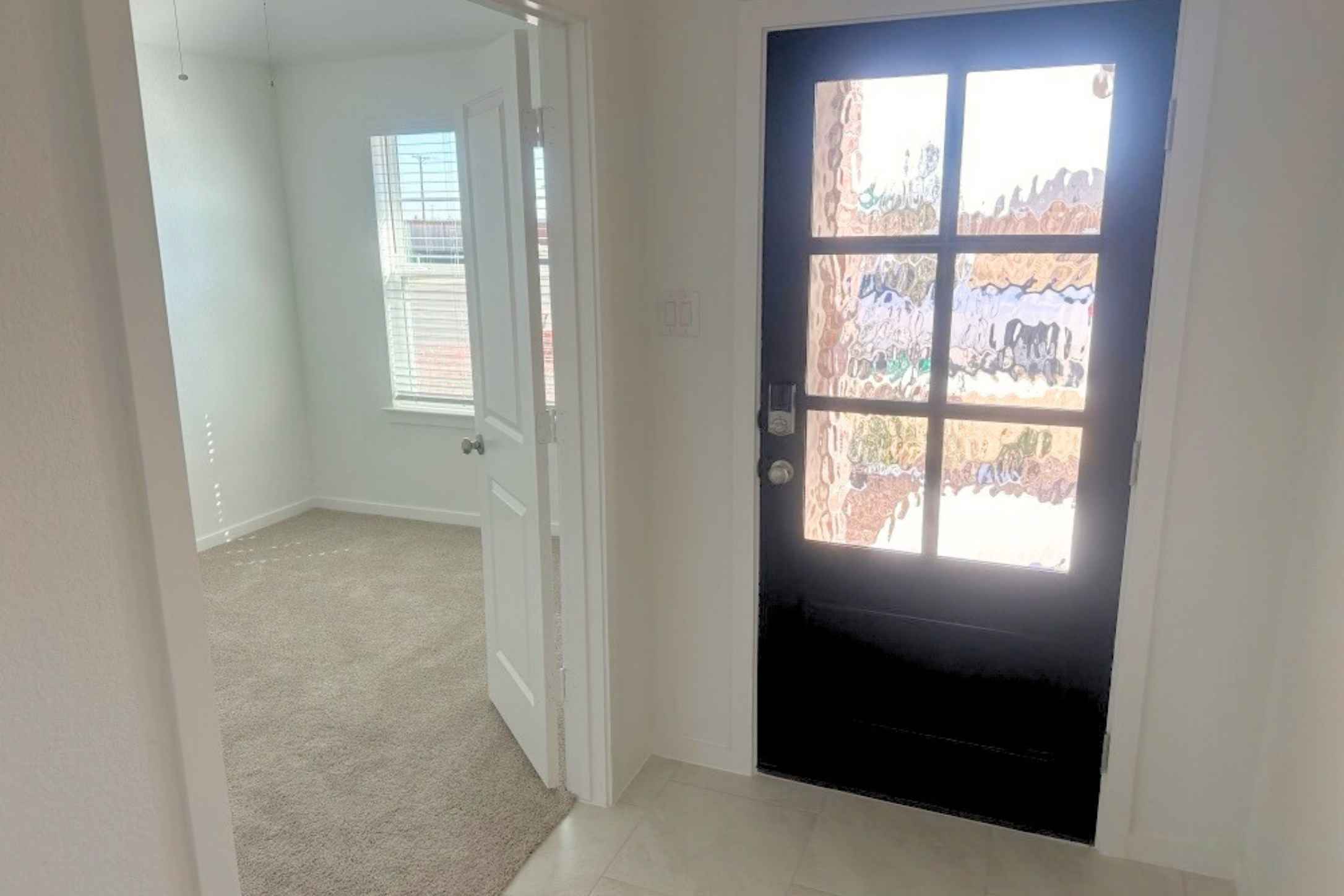 13832 Scarlett Song Drive Elgin, TX 78621 - Photo 2 of 19 Doorway with carpet and baseboards