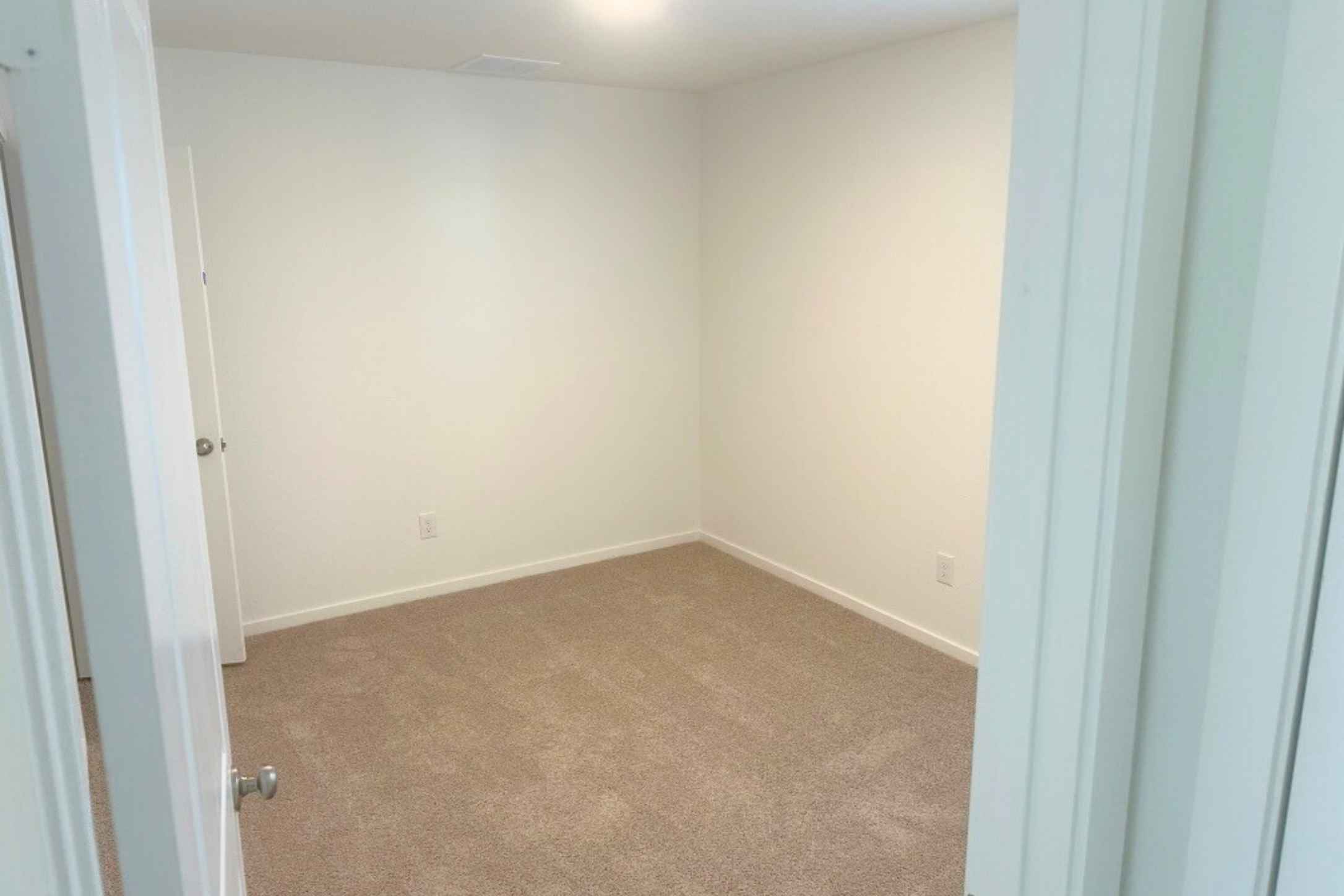 13832 Scarlett Song Drive Elgin, TX 78621 - Photo 6 of 19 Empty room featuring carpet flooring and baseboards