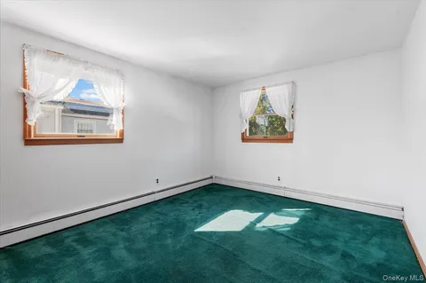 a view of room with window and hallway