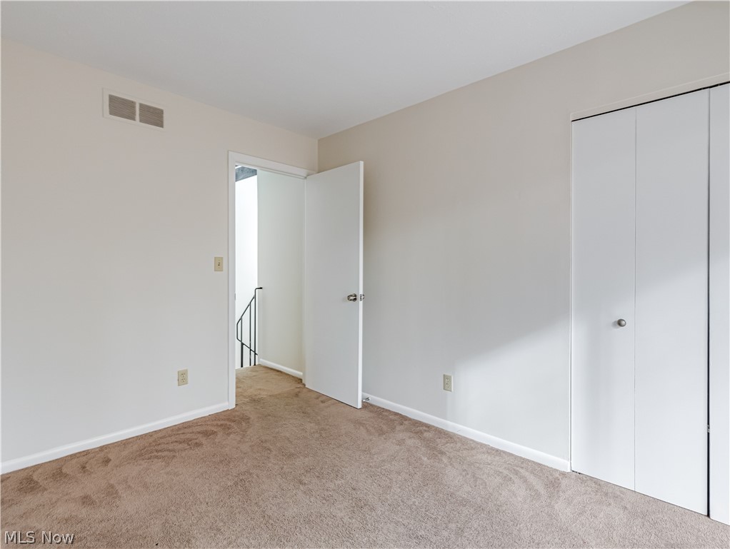 2550 Chamberlain Road, Unit A3 Akron, OH 44333 - Photo 19 of 21 Unfurnished bedroom featuring light colored carpet and a closet