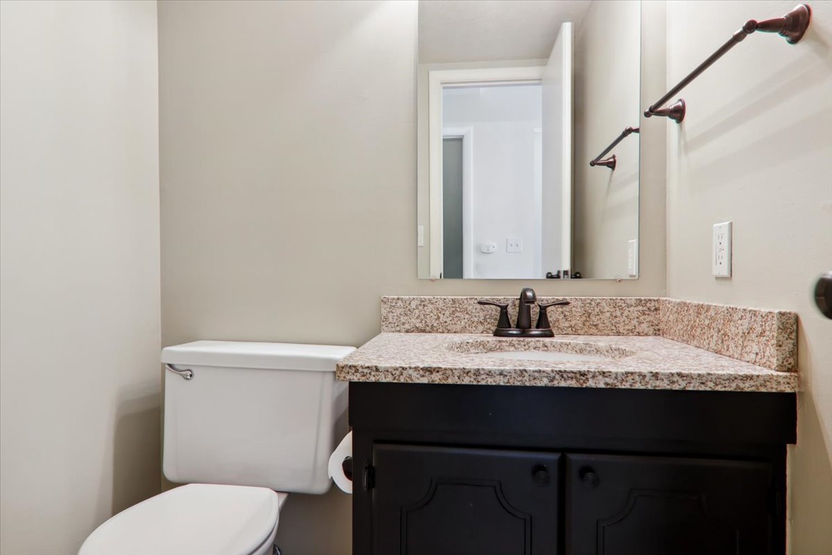 1544 Hunt Drive, Unit D Normal, IL 61761 - Photo 11 of 18 a bathroom with a granite countertop sink toilet and mirror