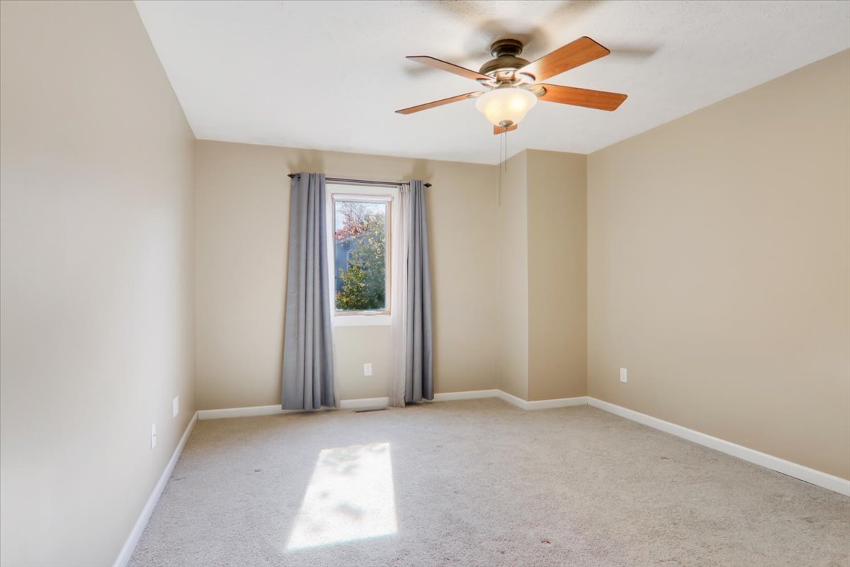1544 Hunt Drive, Unit D Normal, IL 61761 - Photo 13 of 18 an empty room with a window and a ceiling fan