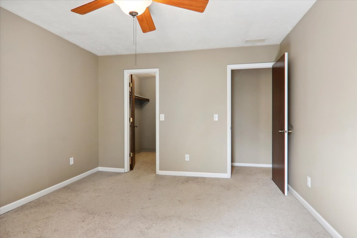 1544 Hunt Drive, Unit D Normal, IL 61761 - Photo 14 of 18 an empty room with closet and fan