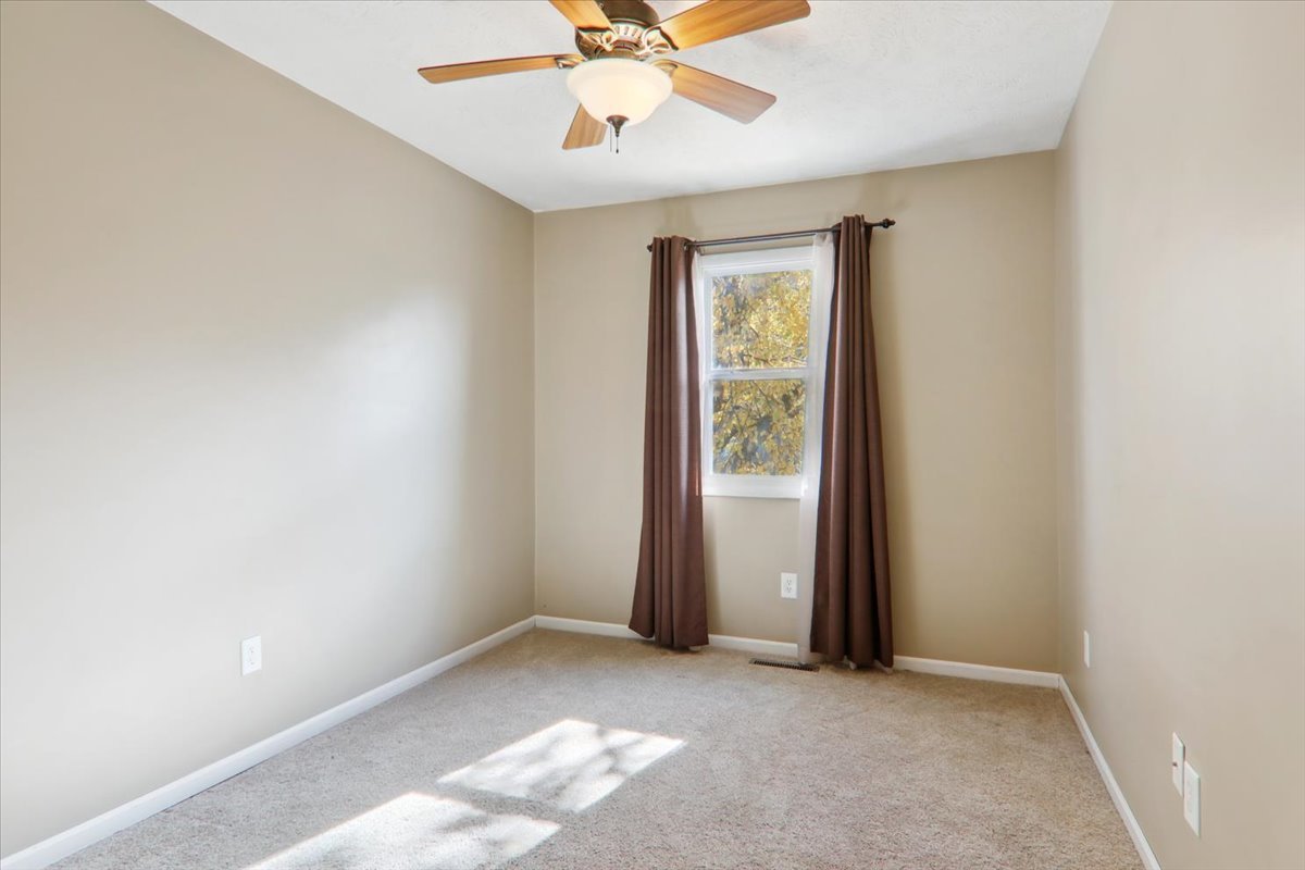1544 Hunt Drive, Unit D Normal, IL 61761 - Photo 15 of 18 an empty room with closet and a chandelier fan