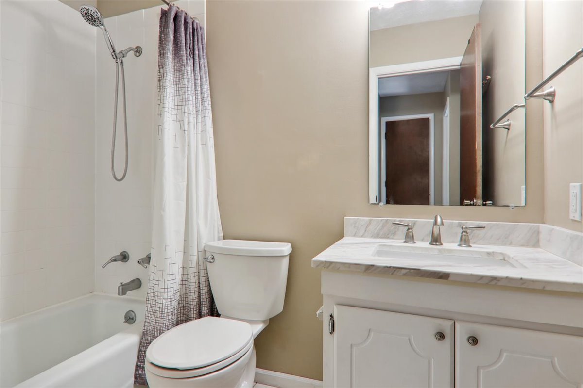 1544 Hunt Drive, Unit D Normal, IL 61761 - Photo 16 of 18 a bathroom with a sink a toilet and shower