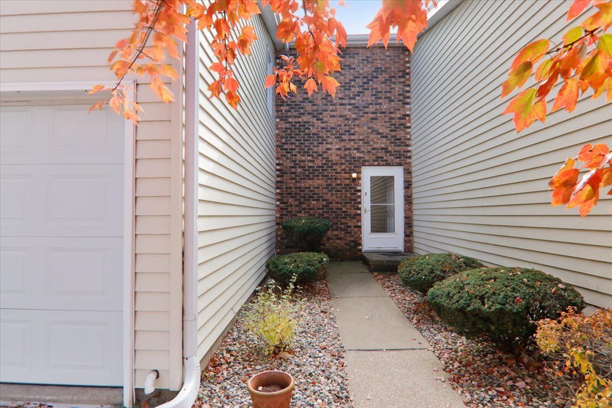 1544 Hunt Drive, Unit D Normal, IL 61761 - Photo 2 of 18 a backyard of a house with chairs and a fire pit