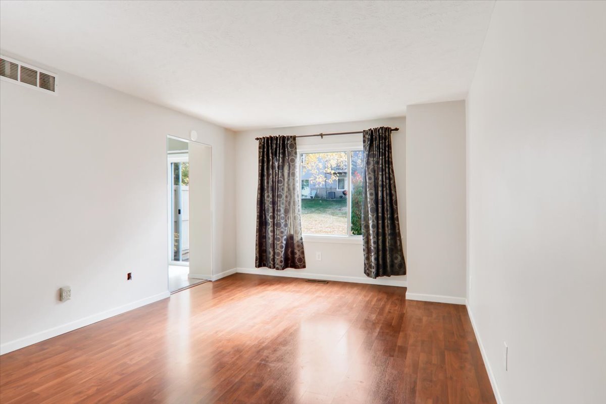 1544 Hunt Drive, Unit D Normal, IL 61761 - Photo 3 of 18 an empty room with wooden floor and windows