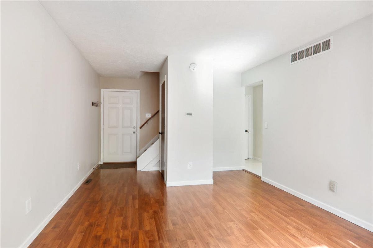 1544 Hunt Drive, Unit D Normal, IL 61761 - Photo 4 of 18 a view of empty room with wooden floor