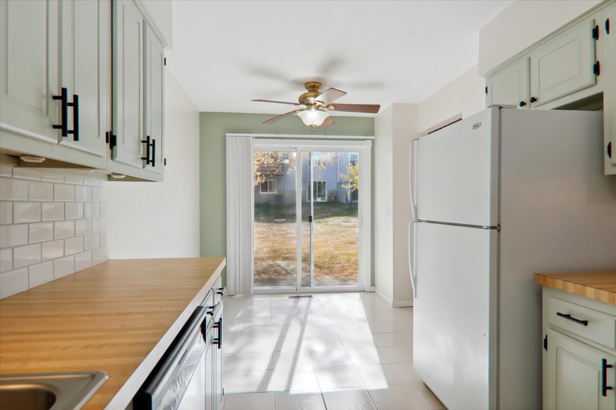 1544 Hunt Drive, Unit D Normal, IL 61761 - Photo 6 of 18 a view of a kitchen with a stove and a cabinet