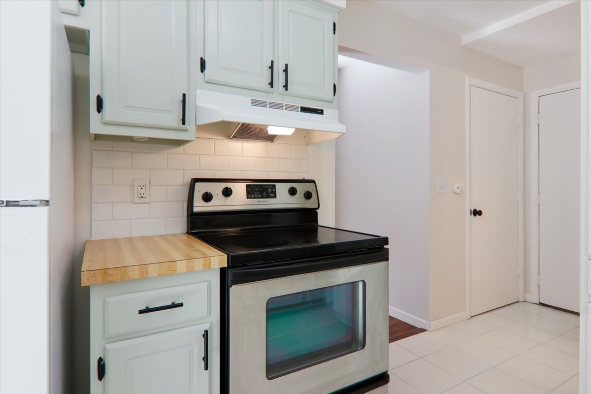 1544 Hunt Drive, Unit D Normal, IL 61761 - Photo 8 of 18 a kitchen with a stove and a microwave