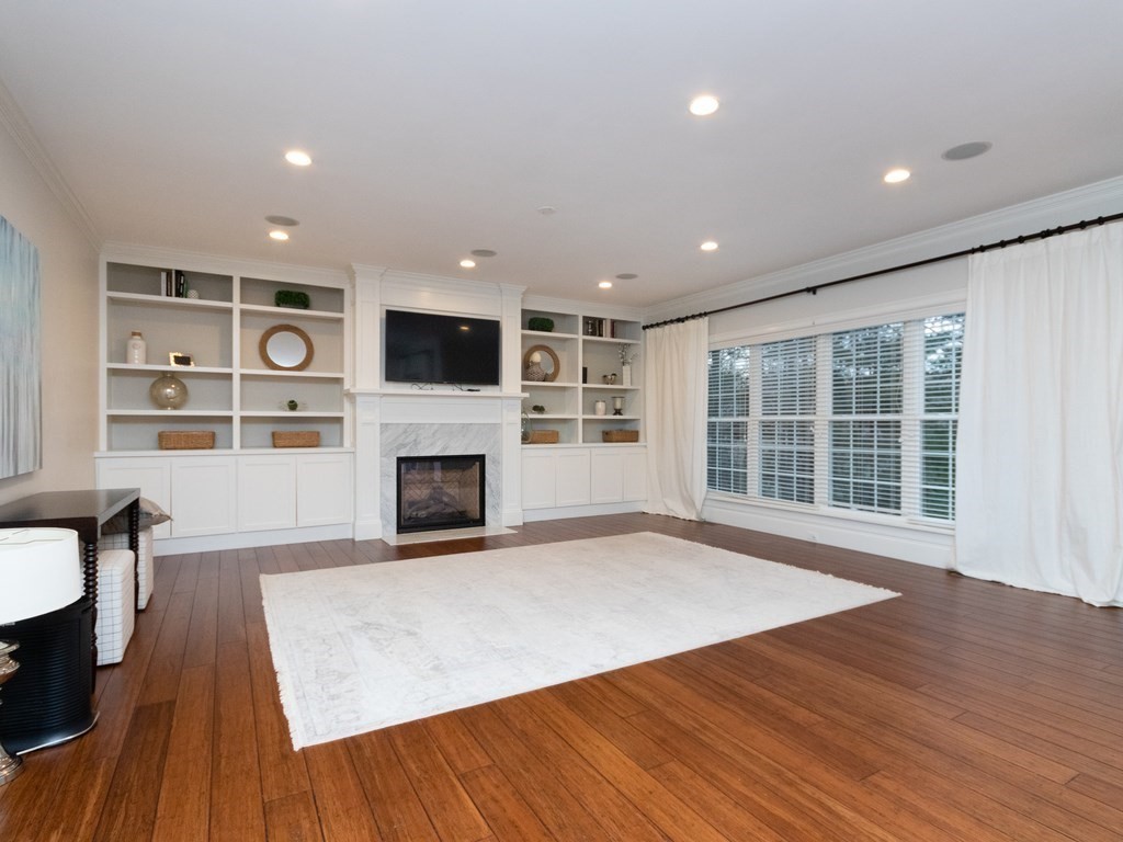 7 Garrett Spillane Road Foxboro, MA 02035 - Photo 11 of 36 a view of a big room with wooden floor and a fireplace
