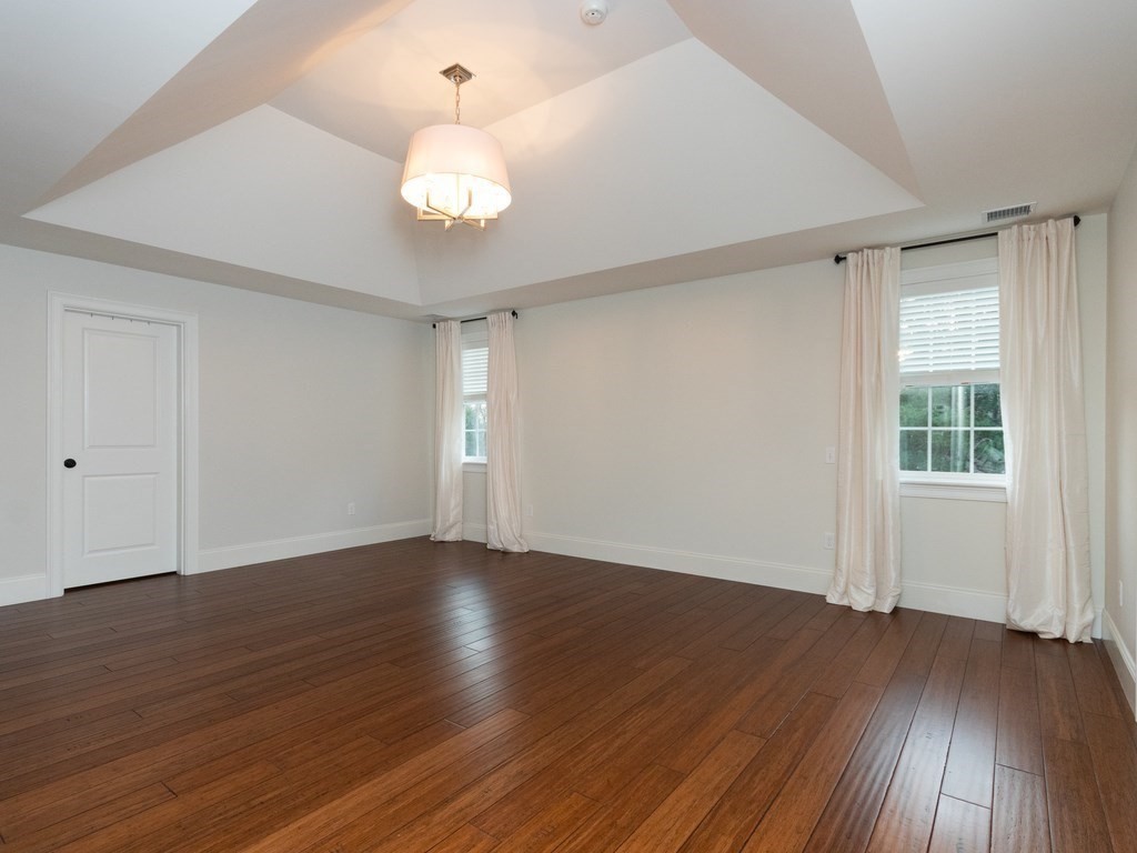 7 Garrett Spillane Road Foxboro, MA 02035 - Photo 18 of 36 an empty room with wooden floor and windows