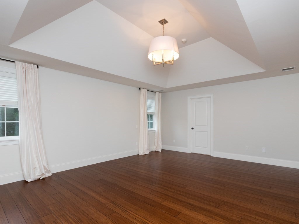 7 Garrett Spillane Road Foxboro, MA 02035 - Photo 20 of 36 an empty room with wooden floor and windows