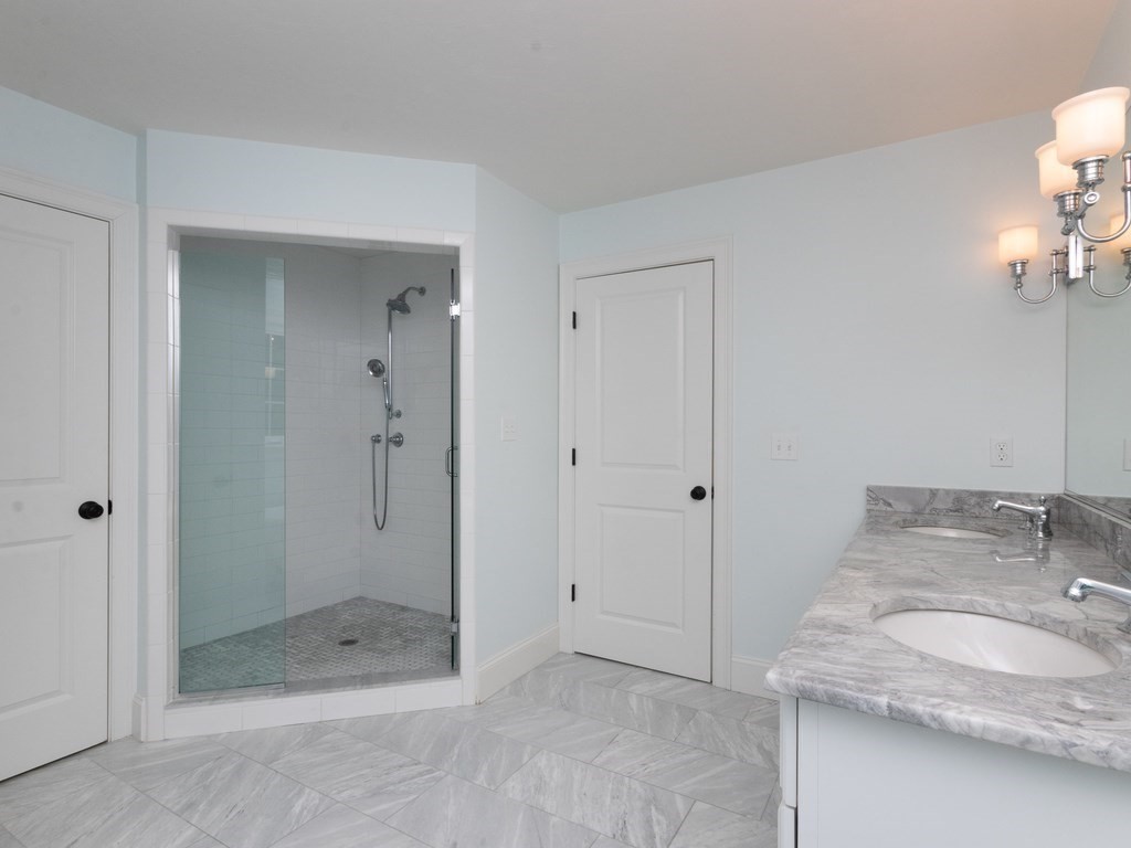7 Garrett Spillane Road Foxboro, MA 02035 - Photo 22 of 36 a bathroom with a granite countertop sink a mirror and shower