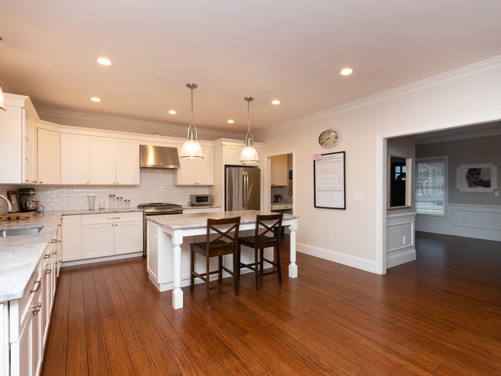 7 Garrett Spillane Road Foxboro, MA 02035 - Photo 5 of 36 a kitchen with a table chairs wooden floors and a view of living room