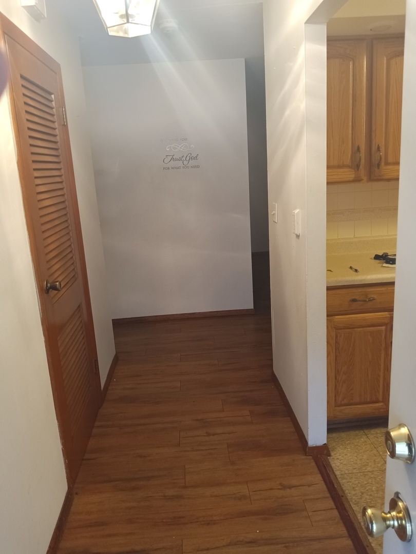 2208 Dale Drive Champaign, IL 61821 - Photo 2 of 12 a view of a hallway with wooden floor and staircase