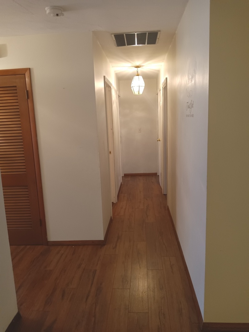 2208 Dale Drive Champaign, IL 61821 - Photo 6 of 12 a view of a hallway with wooden floor