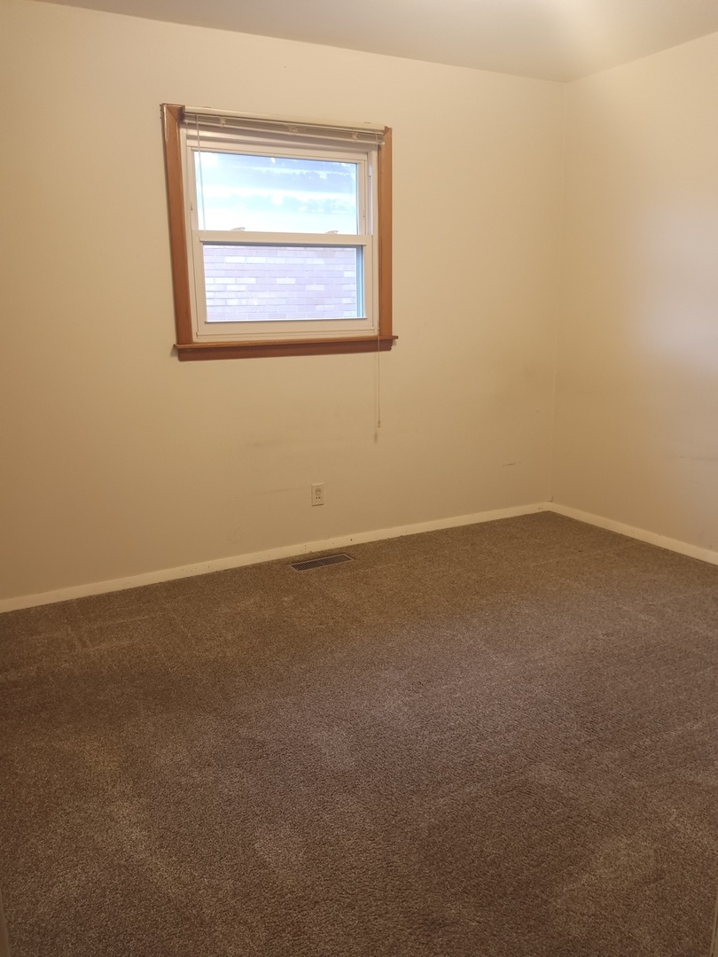 2208 Dale Drive Champaign, IL 61821 - Photo 7 of 12 an empty room with a window