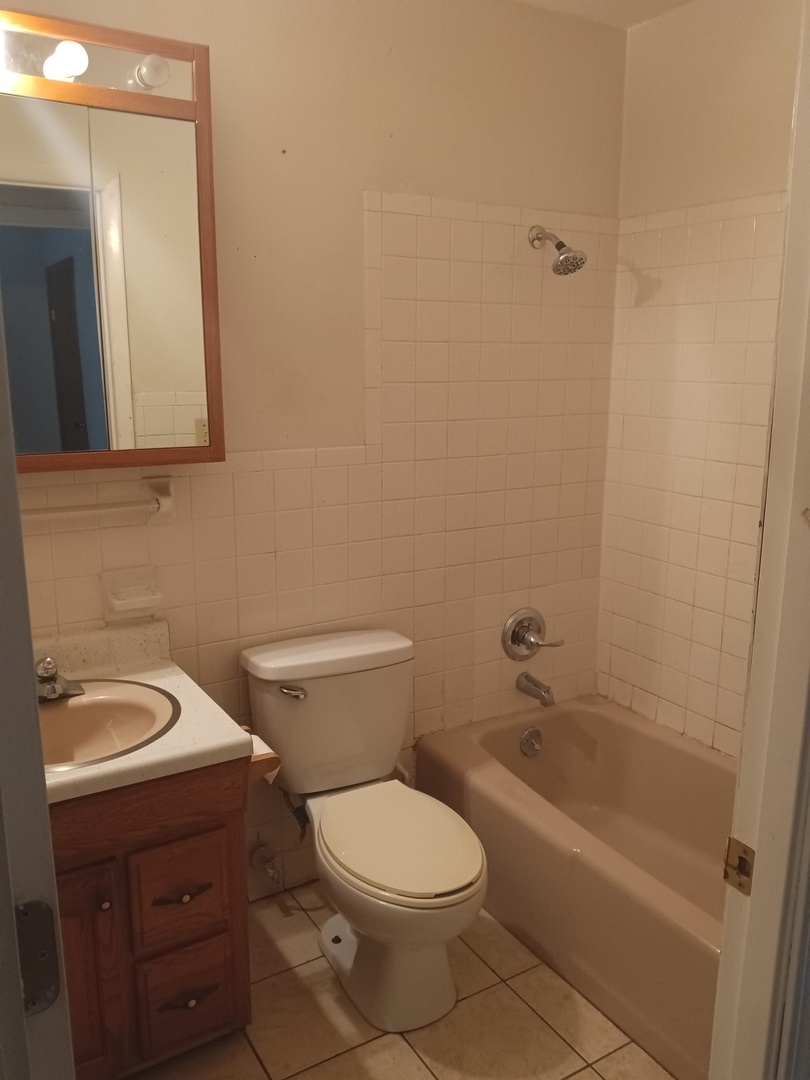 2208 Dale Drive Champaign, IL 61821 - Photo 8 of 12 a white toilet sitting next to a bath tub