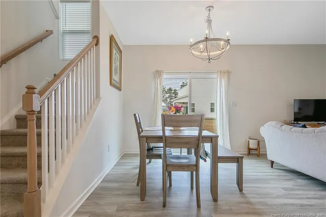 a view of a dining room with furniture and wooden floor