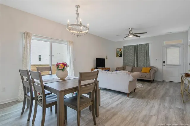 a view of a dining room with furniture and wooden floor