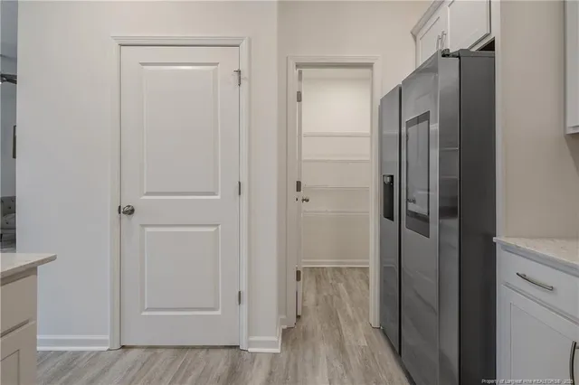 a view of a hallway with wooden floor