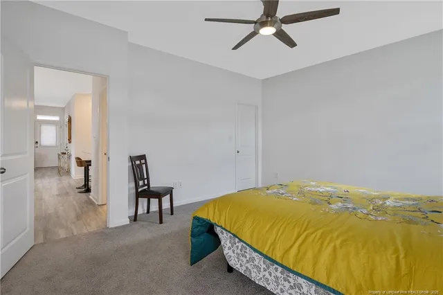 a bedroom with a bed and ceiling fan