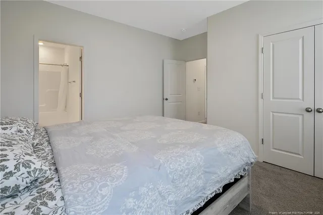 a bedroom with a bed and a mirror