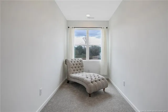 a room with a bed and two window