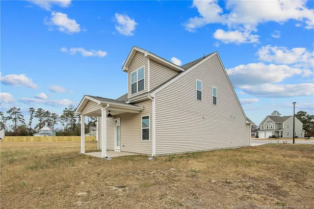 a view of a white house with a yard