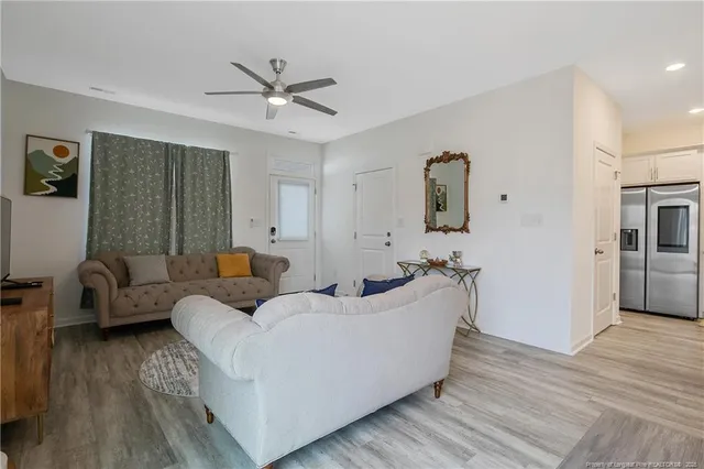a living room with furniture and a wooden floor
