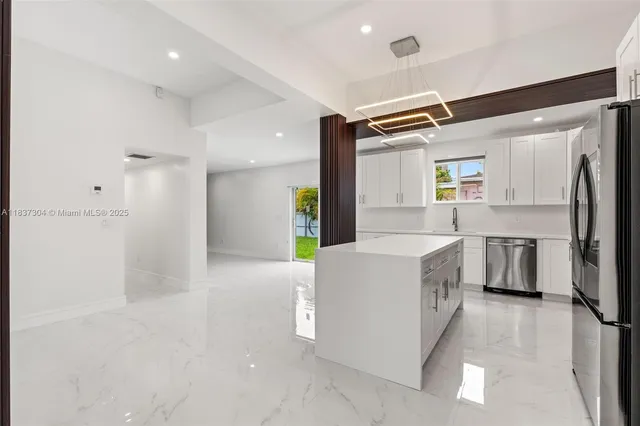 a kitchen with a refrigerator a sink and dishwasher