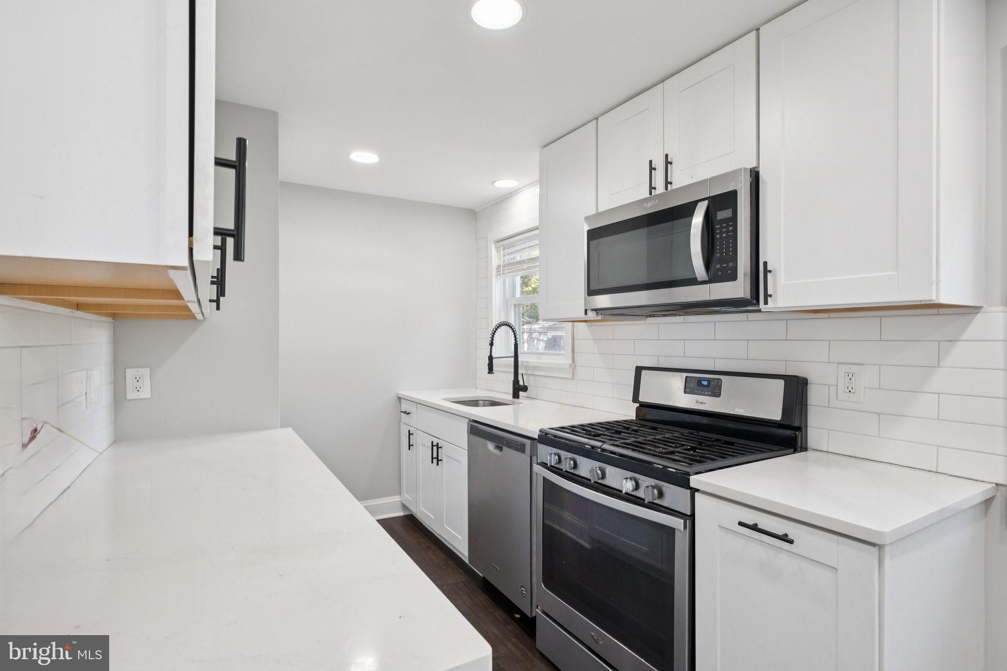 271 Drexel Avenue Lansdowne, PA 19050 - Photo 11 of 27 a kitchen with stainless steel appliances a stove microwave and sink