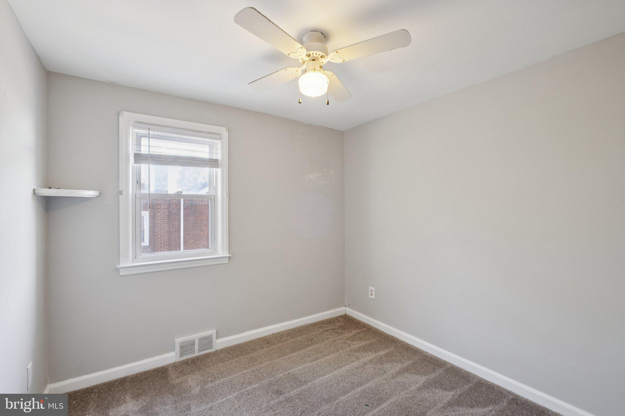 271 Drexel Avenue Lansdowne, PA 19050 - Photo 21 of 27 an empty room with a chandelier fan and windows