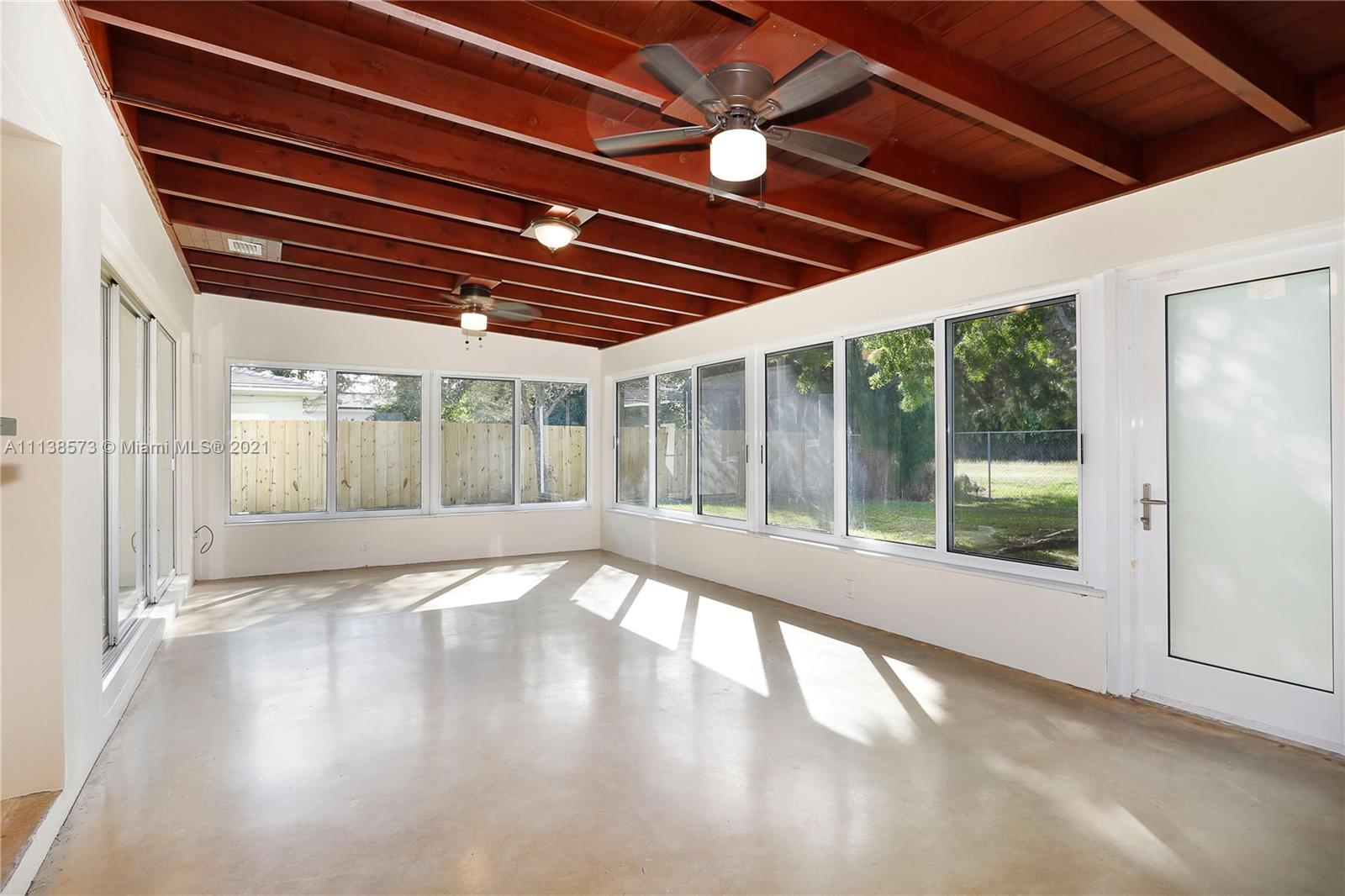 Glenvar Heights Miami, FL 33155 - Photo 12 of 22 a view of an empty room with wooden floor and a window