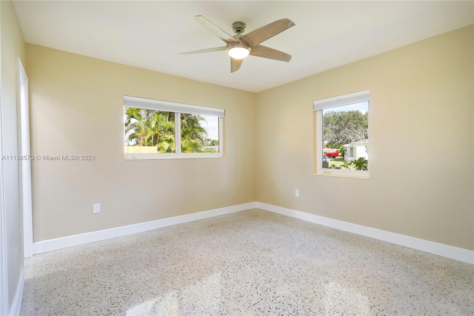 Glenvar Heights Miami, FL 33155 - Photo 15 of 22 an empty room with a window and a ceiling fan