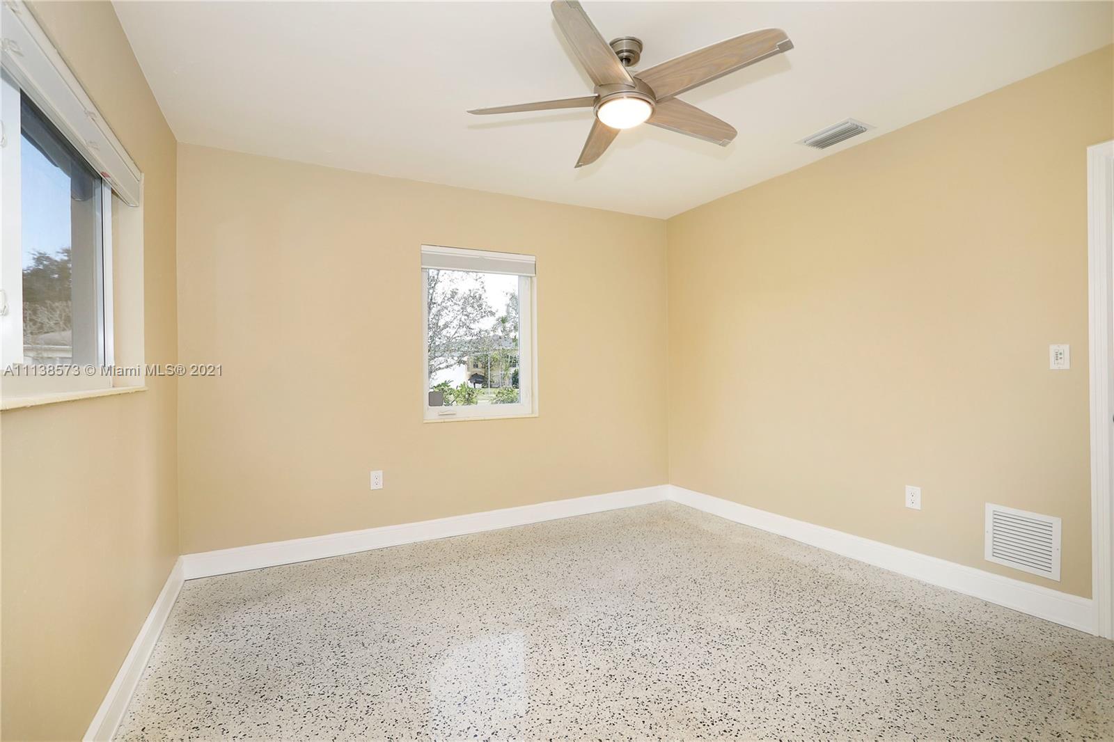 Glenvar Heights Miami, FL 33155 - Photo 18 of 22 an empty room with a window and a fan