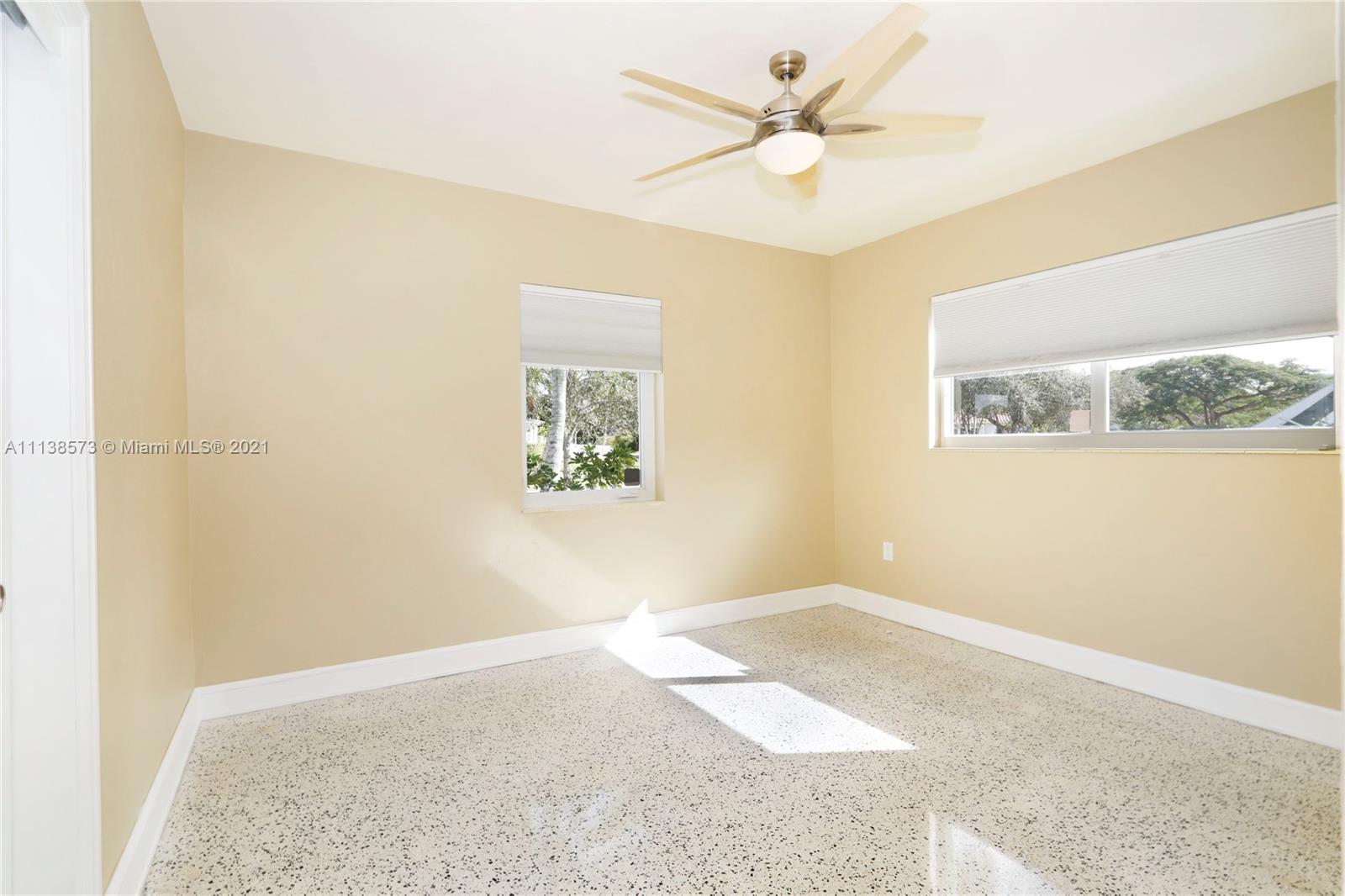 Glenvar Heights Miami, FL 33155 - Photo 19 of 22 a view of a big room with a chandelier fan and a window