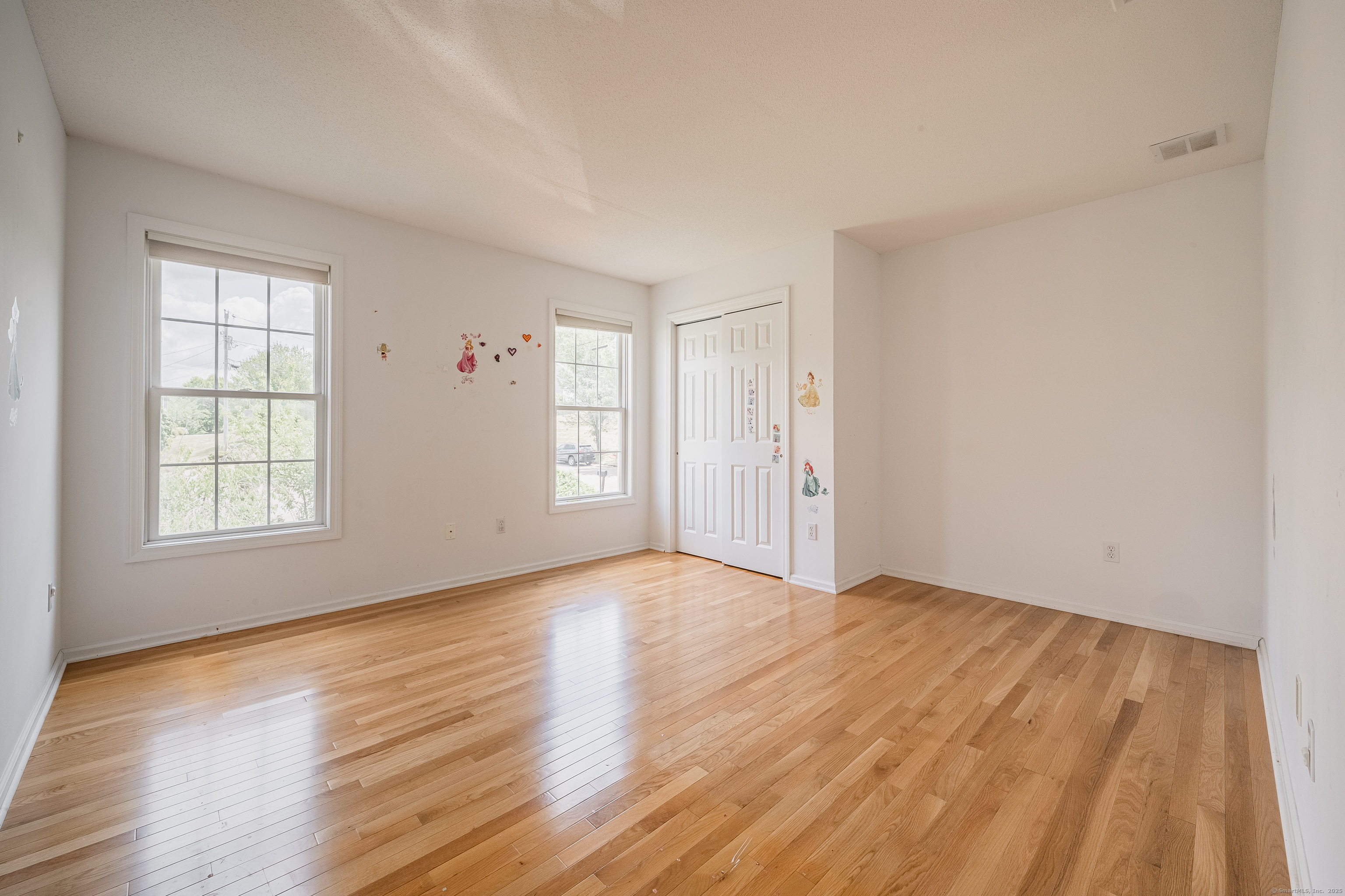 52 Quarry Lane Hamden, CT 06518 - Photo 23 of 29 an empty room with wooden floor and windows