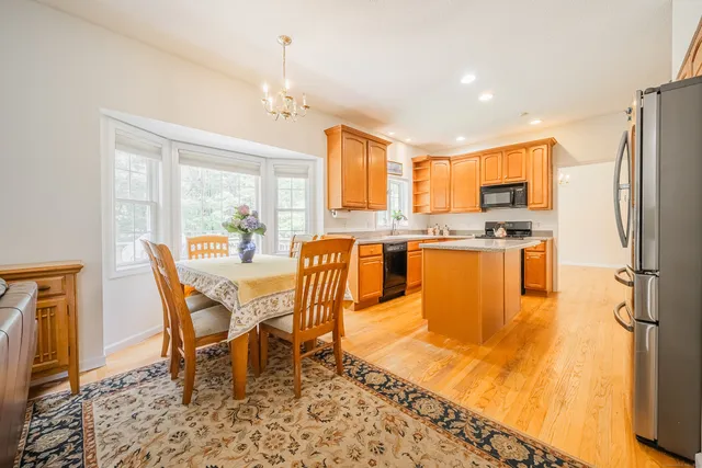 a view of a dining room with furniture a chandelier and wooden floor