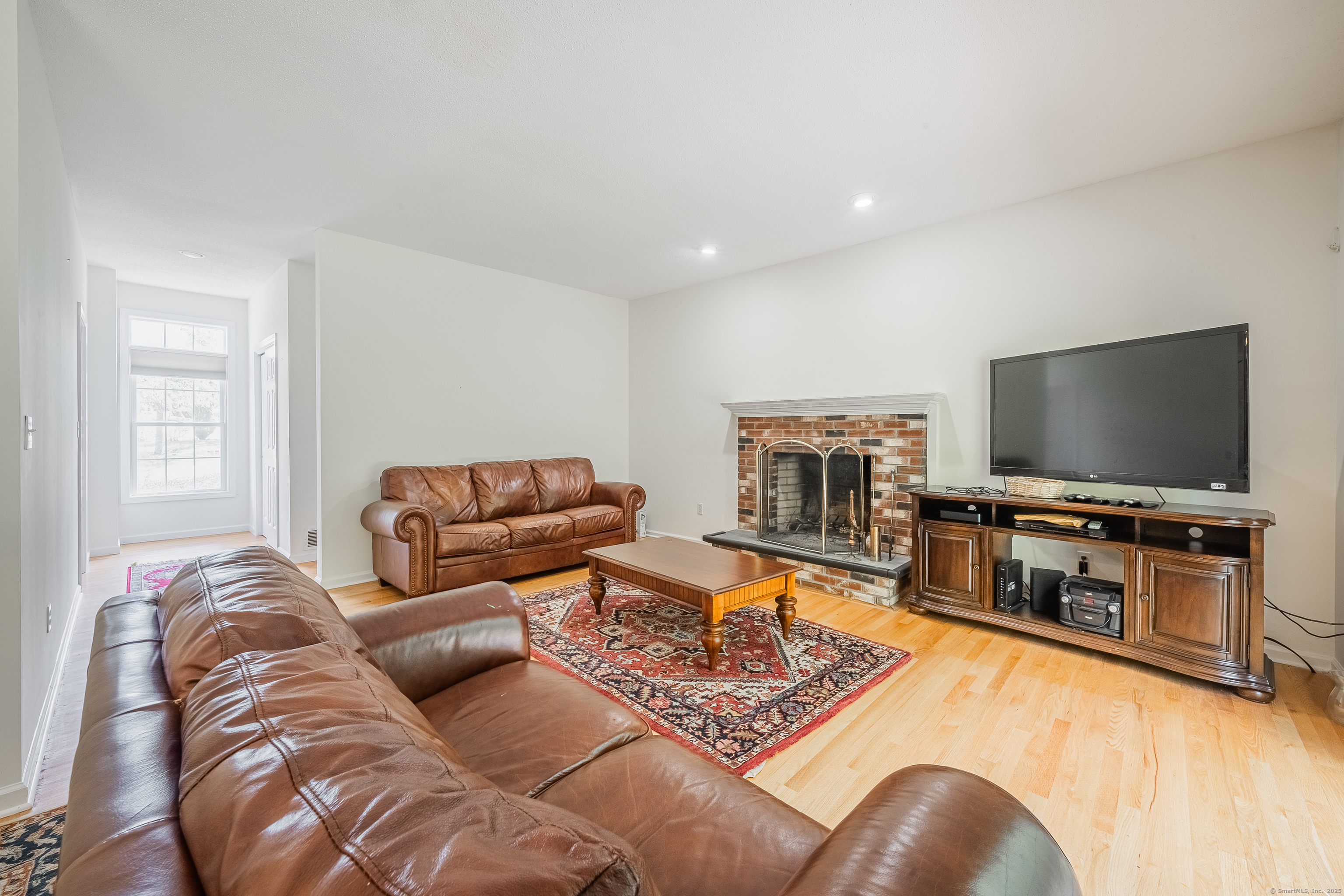 52 Quarry Lane Hamden, CT 06518 - Photo 7 of 29 a living room with furniture and a flat screen tv