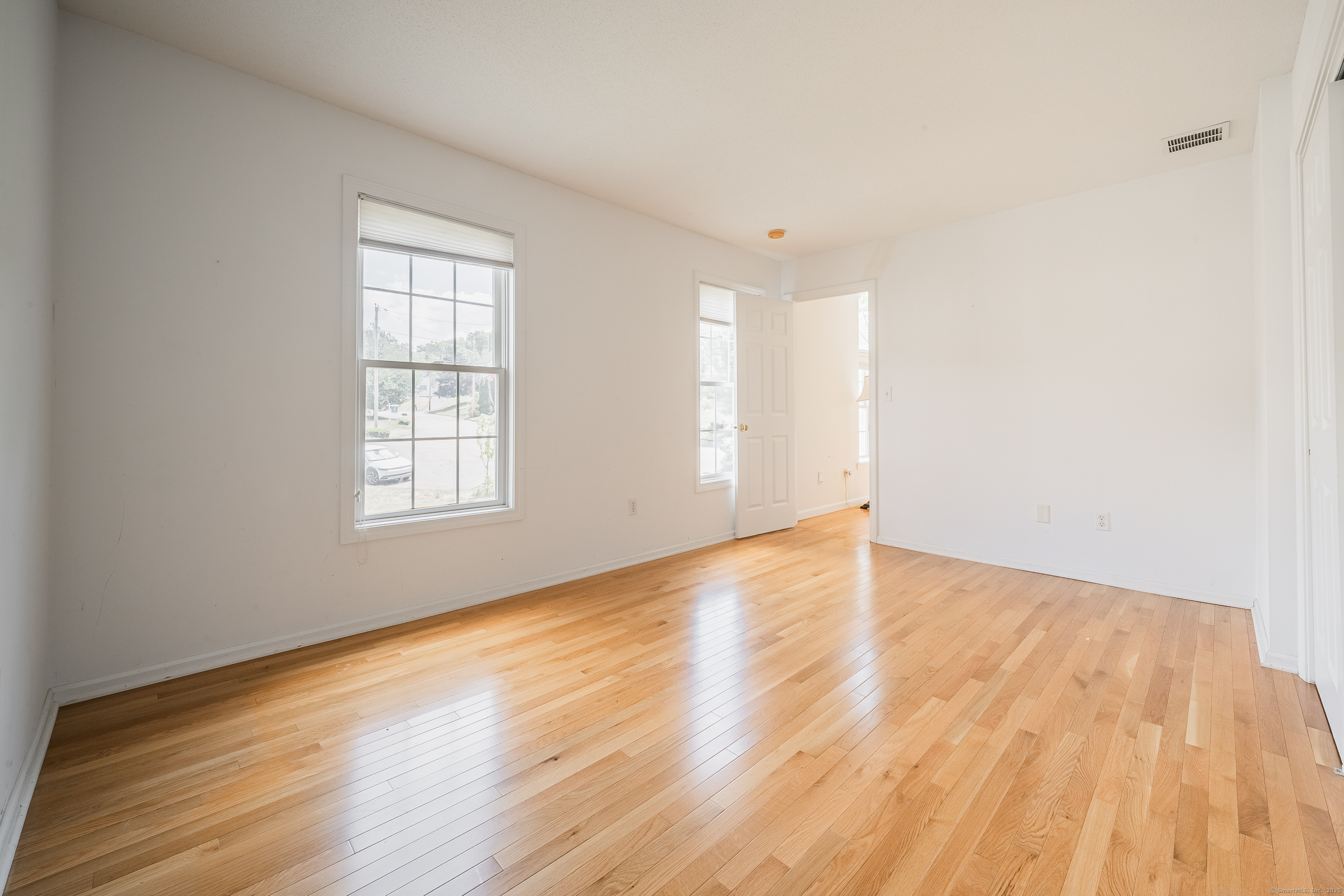 52 Quarry Lane Hamden, CT 06518 - Photo 10 of 29 an empty room with wooden floor and windows
